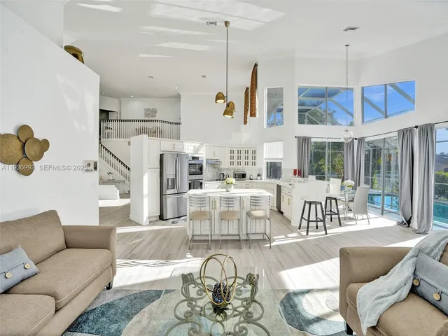 a kitchen with stainless steel appliances kitchen island granite countertop a sink and cabinets