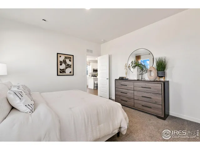 a bedroom with a bed and a dresser