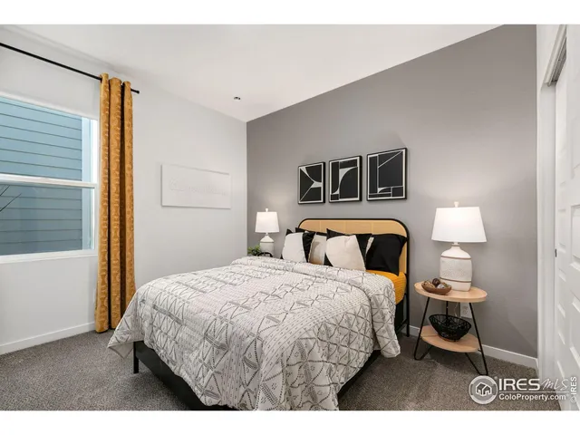 a bedroom with a bed and a night stand