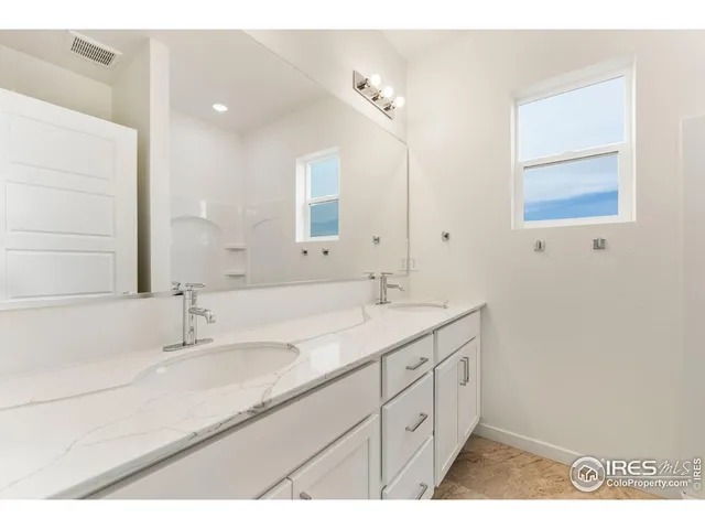 a bathroom with a sink double vanity and a mirror