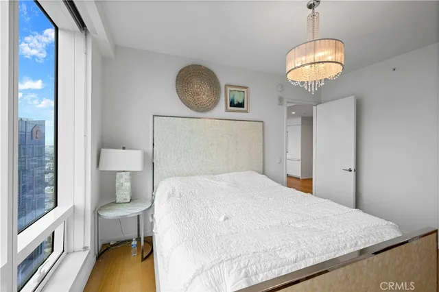 a bedroom with a bed and chandelier