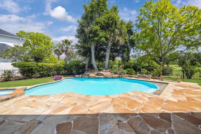 a view of a swimming pool with a yard