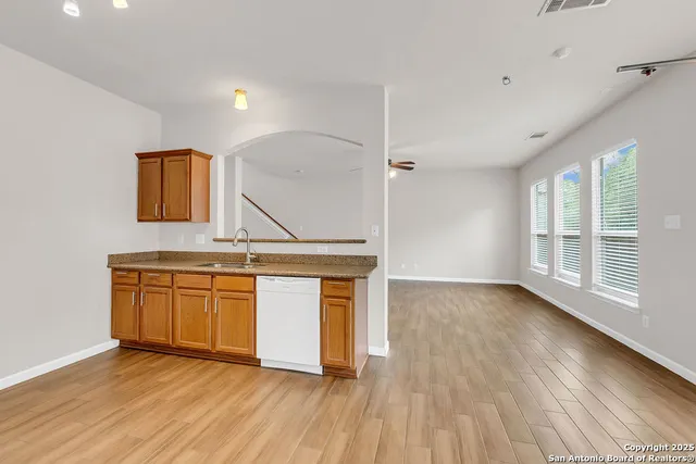 a view of kitchen with granite countertop cabinets and wooden floor