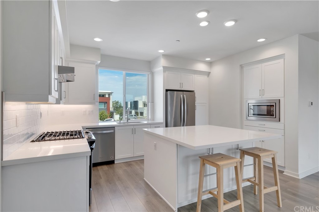 194 Novel Irvine, CA 92618 - Photo 1 of 15 a kitchen with a table and chairs