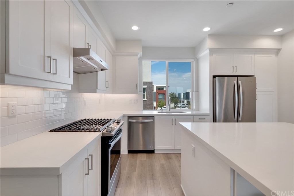 194 Novel Irvine, CA 92618 - Photo 6 of 15 a kitchen with stainless steel appliances kitchen island a sink stove and cabinets