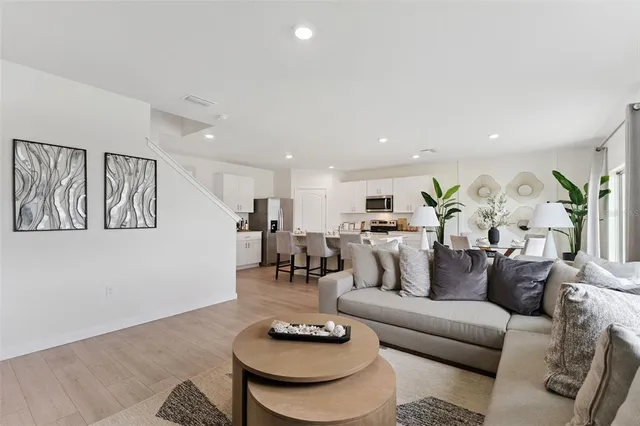 a living room with furniture and kitchen view