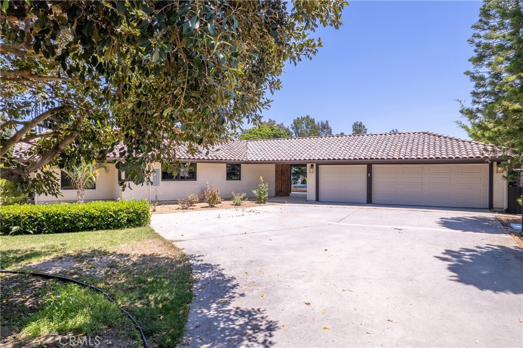 7337 La Soldadera Rancho Santa Fe, CA 92067 - Photo 3 of 60 a front view of a house with a yard and a garage