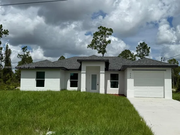 a front view of a house with a garden