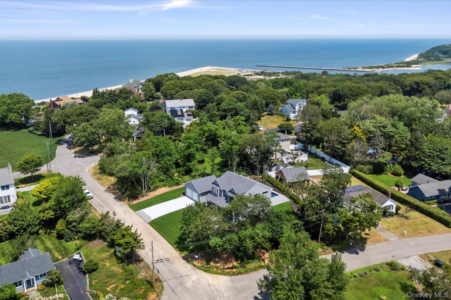 Aerial perspective of suburban area with a large body of water