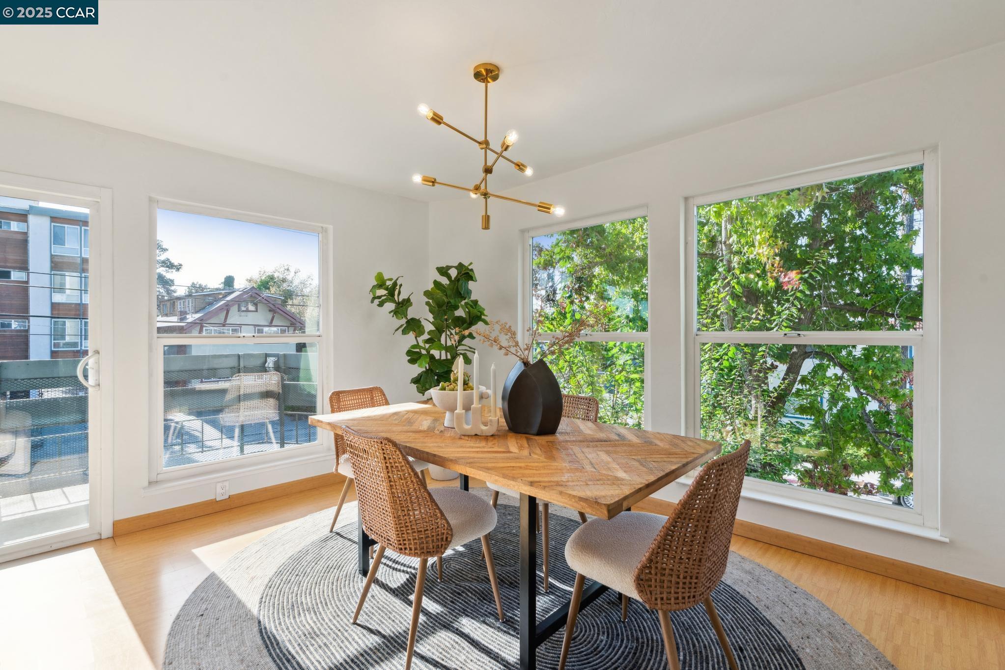 500 Vernon Street, Unit 102 Oakland, CA 94610 - Photo 6 of 43 a view of a dining room with furniture window and wooden floor
