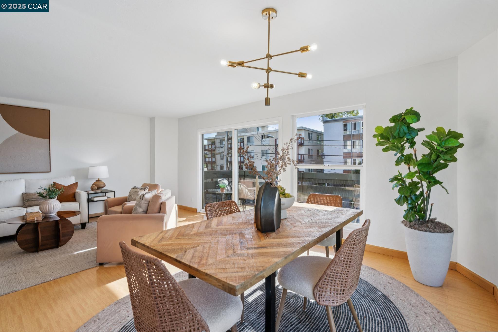 500 Vernon Street, Unit 102 Oakland, CA 94610 - Photo 8 of 43 a dining room with furniture potted plants and wooden floor