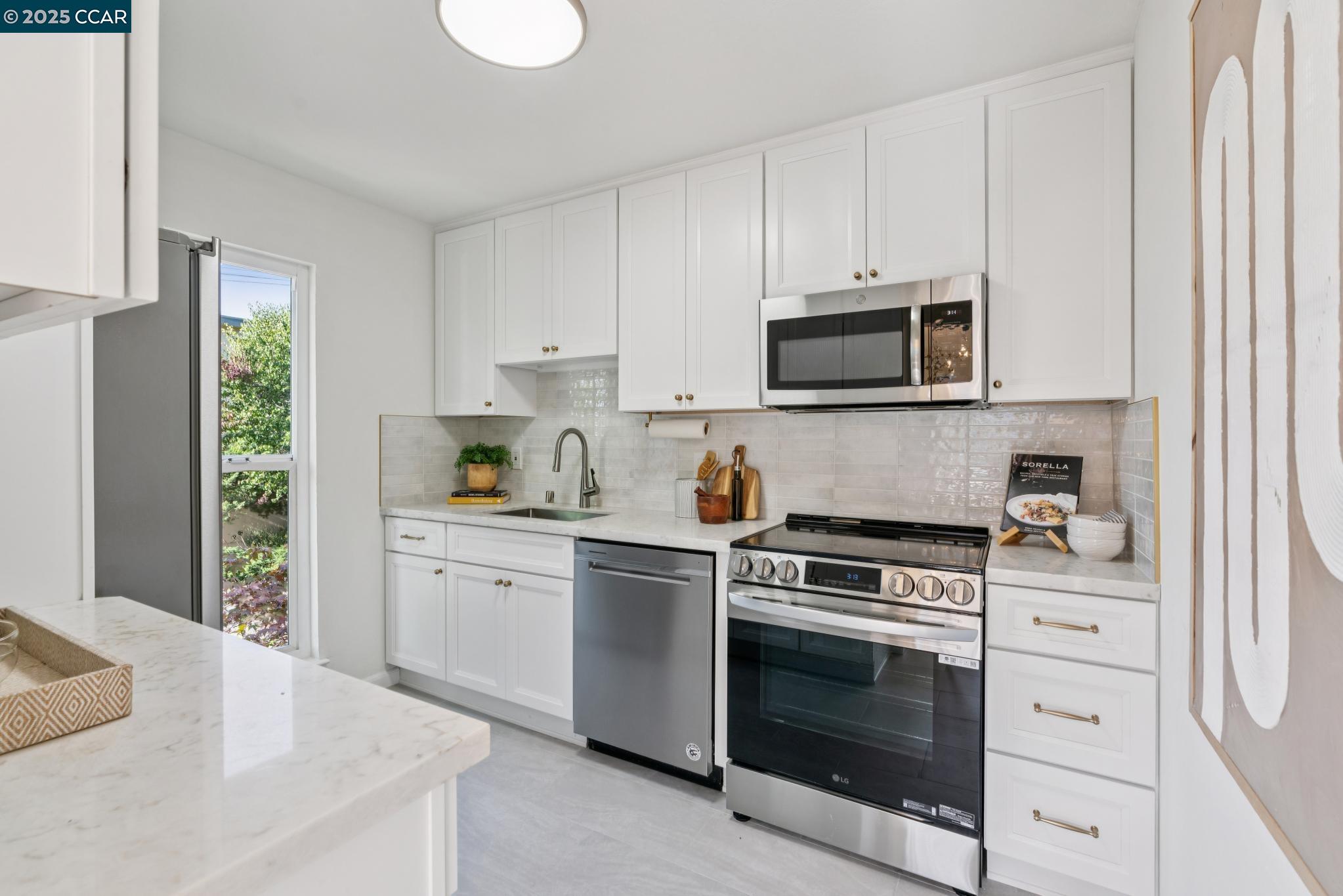 500 Vernon Street, Unit 102 Oakland, CA 94610 - Photo 10 of 43 a kitchen with cabinets stainless steel appliances and a window