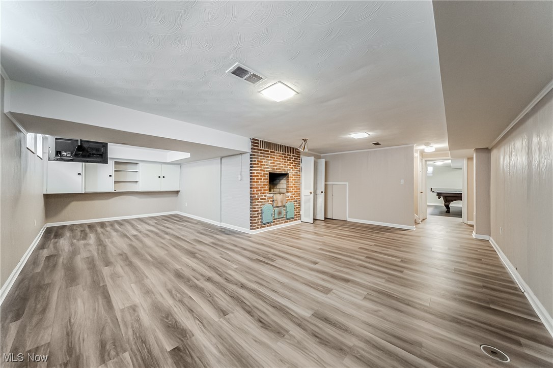 18201 Shelburne Road Cleveland, OH 44118 - Photo 27 of 36 Basement featuring a built in grill and wood-style flooring