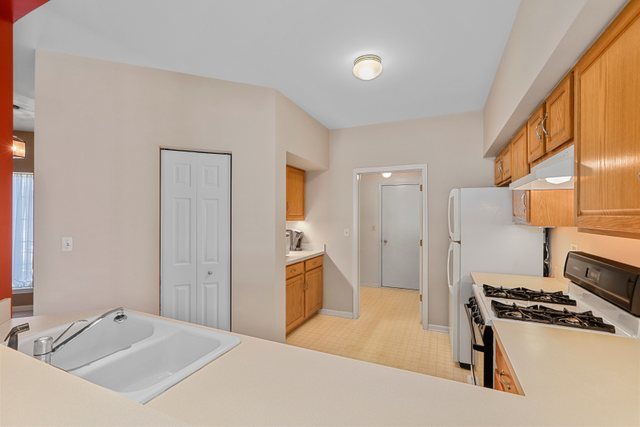 8171 Ripple Ridge Darien, IL 60561 - Photo 11 of 25 a room with a stove a sink and a refrigerator
