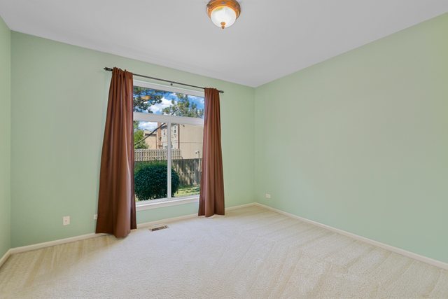 8171 Ripple Ridge Darien, IL 60561 - Photo 14 of 25 a view of an empty room with a window