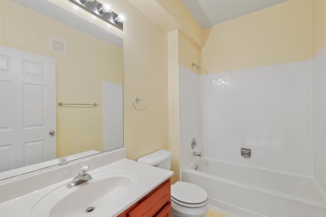 8171 Ripple Ridge Darien, IL 60561 - Photo 19 of 25 a bathroom with a bathtub shower sink vanity mirror and toilet