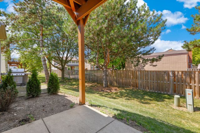 8171 Ripple Ridge Darien, IL 60561 - Photo 21 of 25 a view of a backyard with large trees and wooden fence