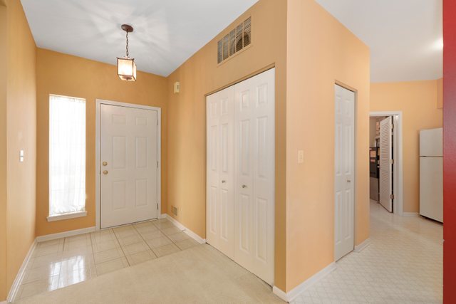 8171 Ripple Ridge Darien, IL 60561 - Photo 5 of 25 a view of a hallway with a chandelier fan
