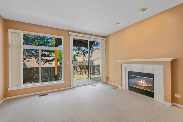 8171 Ripple Ridge Darien, IL 60561 - Photo 6 of 25 a view of an empty room with a fireplace