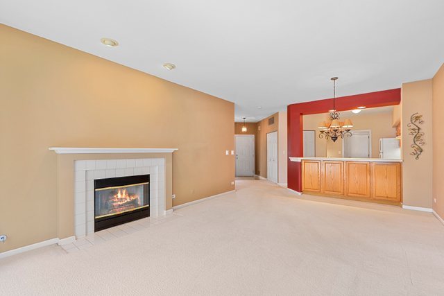 8171 Ripple Ridge Darien, IL 60561 - Photo 7 of 25 a view of an empty room with a fireplace and a window
