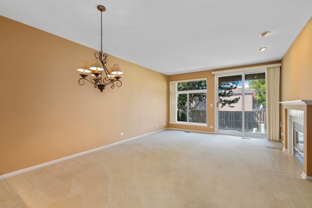 8171 Ripple Ridge Darien, IL 60561 - Photo 9 of 25 a view of empty room with a fireplace