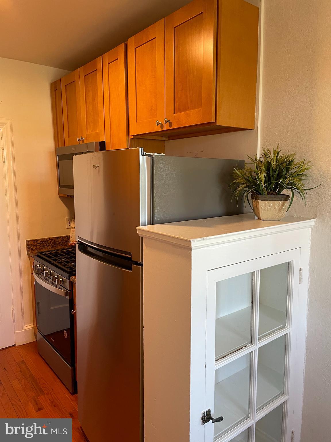 2032 Belmont Road Northwest, Unit 603 Washington, DC 20009 - Photo 11 of 16 a kitchen with a refrigerator and cabinets