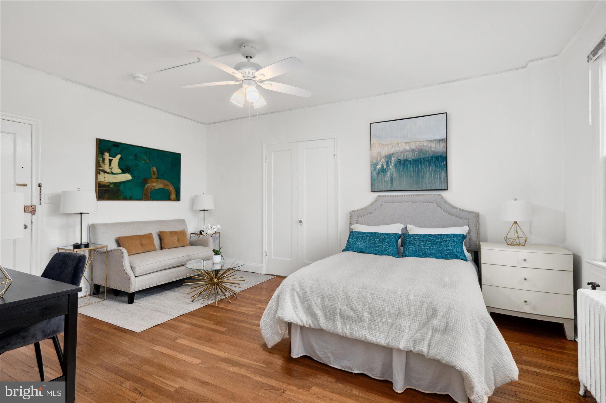 2032 Belmont Road Northwest, Unit 603 Washington, DC 20009 - Photo 7 of 16 a bedroom with a bed and a couch
