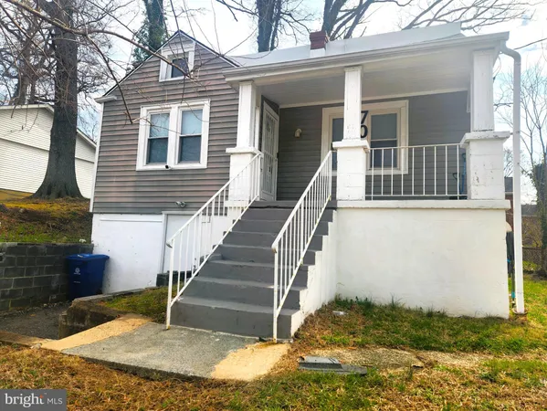 a view of a house with more windows and a small yard