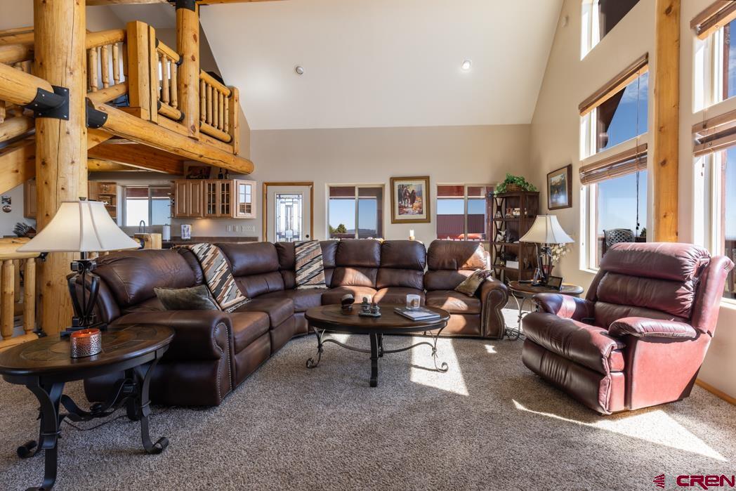 1737 Roberts Ridge Drive Hesperus, CO 81326 - Photo 9 of 34 a living room with furniture a fireplace and a large window