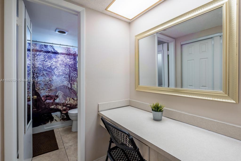 351 Cambridge Road, Unit 208 Hollywood, FL 33024 - Photo 19 of 35 a bathroom with a granite countertop sink a mirror and shower