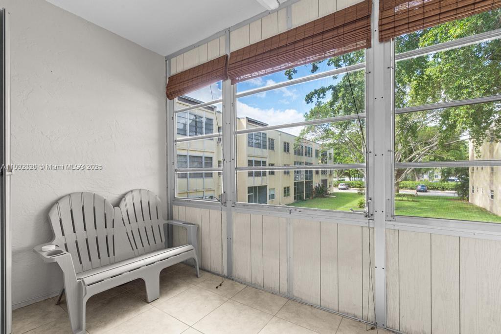 351 Cambridge Road, Unit 208 Hollywood, FL 33024 - Photo 23 of 35 a view of porch with wooden floor