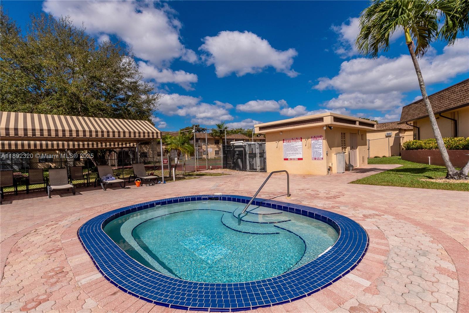 351 Cambridge Road, Unit 208 Hollywood, FL 33024 - Photo 34 of 35 a view of a swimming pool with a patio