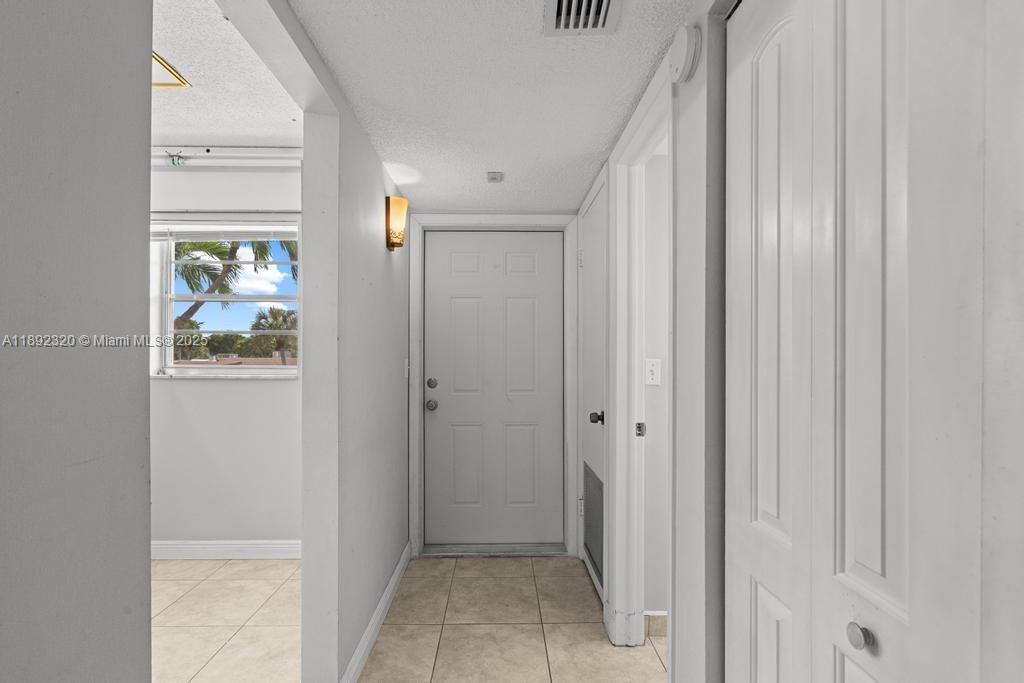 351 Cambridge Road, Unit 208 Hollywood, FL 33024 - Photo 6 of 35 a view of an entryway with wooden floor