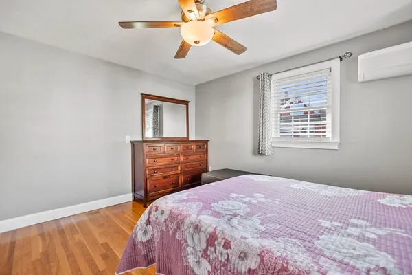 a bedroom with a bed dresser and a window