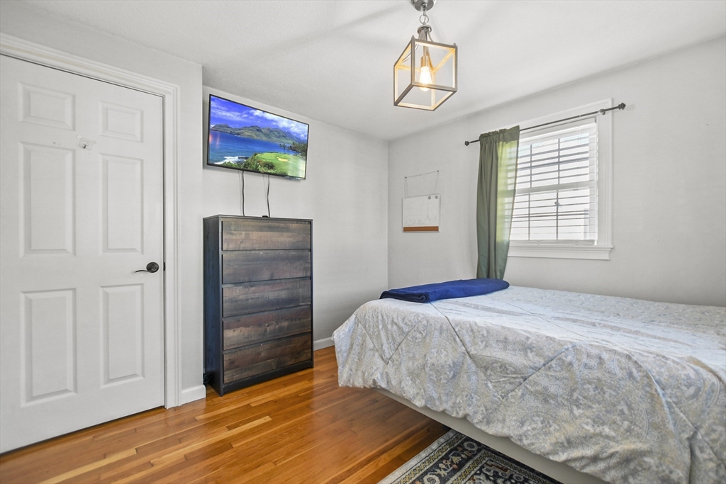 118 1/2 Market Street, Unit 118 1/2 Amesbury, MA 01913 - Photo 13 of 37 a bedroom with a bed and a painting on the wall