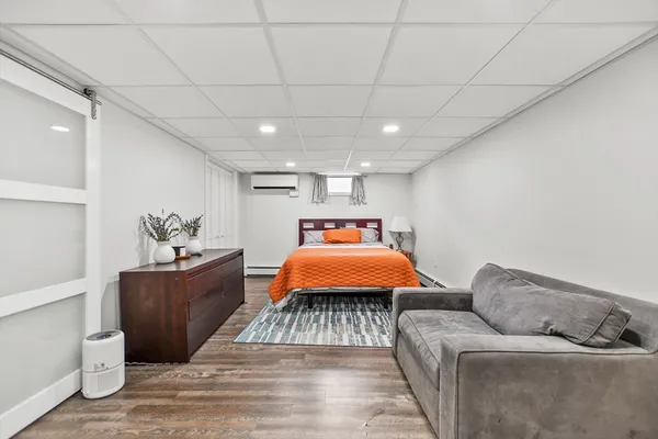 a bedroom with furniture and wooden floor