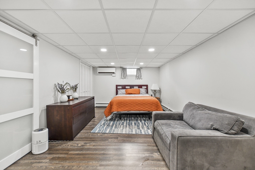 118 1/2 Market Street, Unit 118 1/2 Amesbury, MA 01913 - Photo 16 of 37 a bedroom with furniture and wooden floor