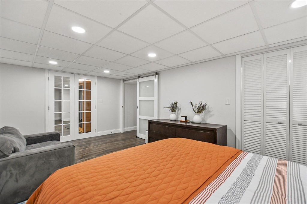 118 1/2 Market Street, Unit 118 1/2 Amesbury, MA 01913 - Photo 18 of 37 a bedroom with a large bed and wooden floor