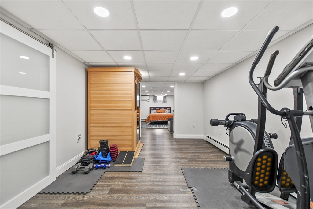 118 1/2 Market Street, Unit 118 1/2 Amesbury, MA 01913 - Photo 20 of 37 a living room with furniture a rug and white walls