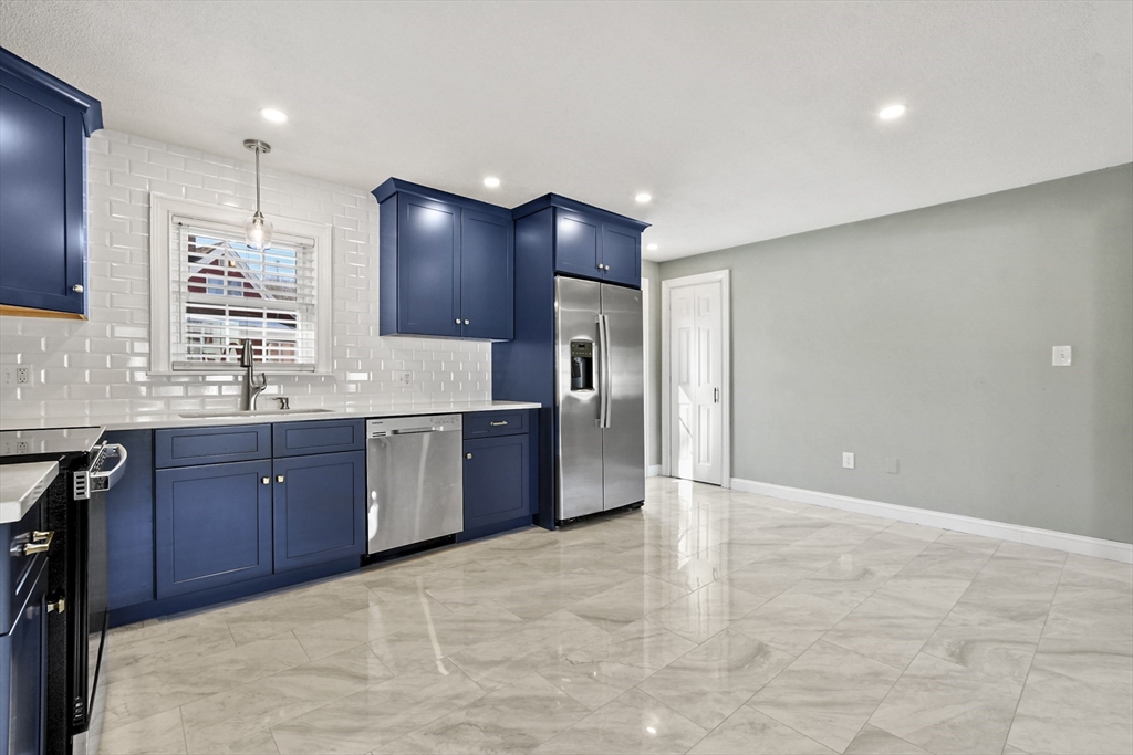 118 1/2 Market Street, Unit 118 1/2 Amesbury, MA 01913 - Photo 2 of 37 a large kitchen with granite countertop a sink and a refrigerator