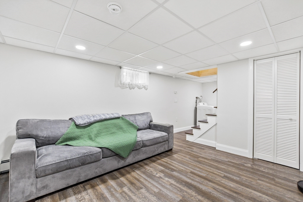 118 1/2 Market Street, Unit 118 1/2 Amesbury, MA 01913 - Photo 22 of 37 a living room with furniture and a wooden floor