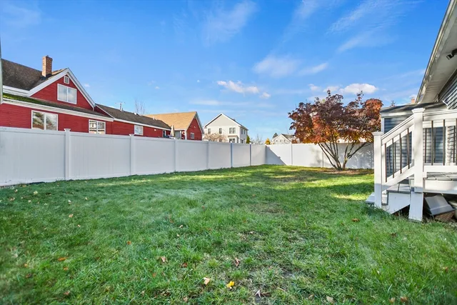 a view of backyard with deck and garden