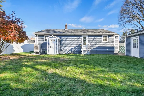 a view of a house with a big yard and large tree