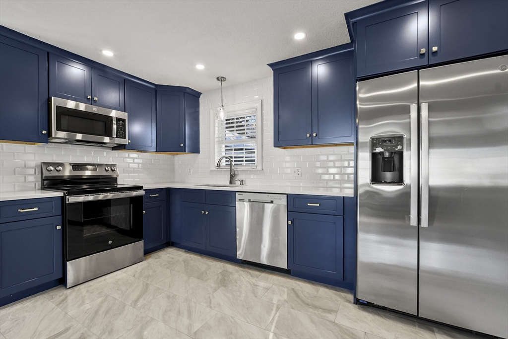 118 1/2 Market Street, Unit 118 1/2 Amesbury, MA 01913 - Photo 3 of 37 a kitchen with granite countertop stainless steel appliances and wooden cabinets