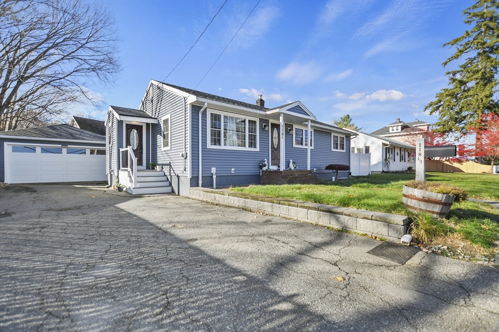 118 1/2 Market Street, Unit 118 1/2 Amesbury, MA 01913 - Photo 32 of 37 a front view of a house with a yard and potted plants