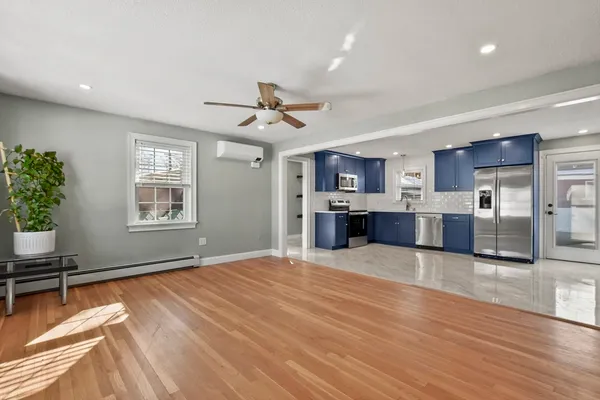 a view of kitchen with cabinets and window