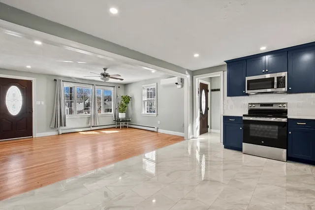a kitchen with stainless steel appliances granite countertop a refrigerator and a stove top oven