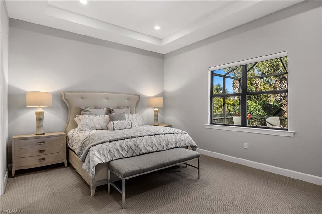 9309 Surfbird Court Naples, FL 34120 - Photo 15 of 45 Bedroom with carpet, a raised ceiling, and recessed lighting