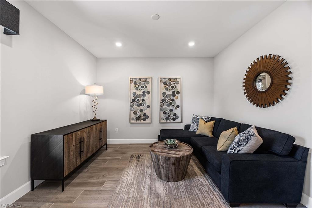 9309 Surfbird Court Naples, FL 34120 - Photo 20 of 45 Living room featuring wood finish floors and recessed lighting