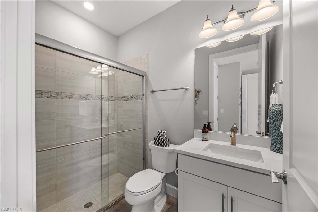 9309 Surfbird Court Naples, FL 34120 - Photo 22 of 45 Bathroom featuring a shower stall and vanity